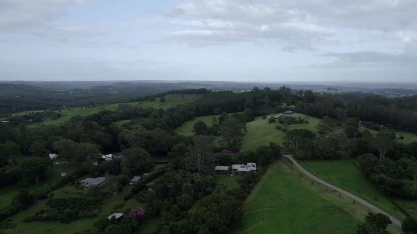 Aerial view of a rural neighborhood with houses far apart with open land and trees