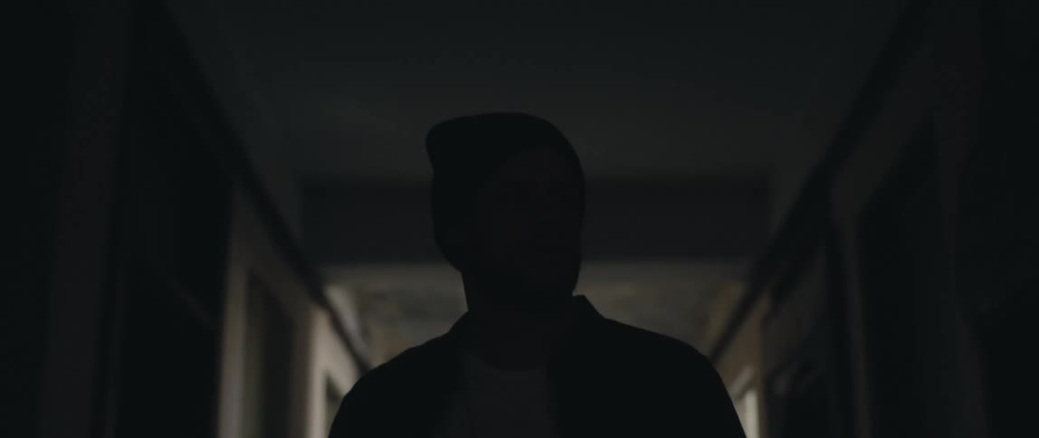A man walking around in a hallway