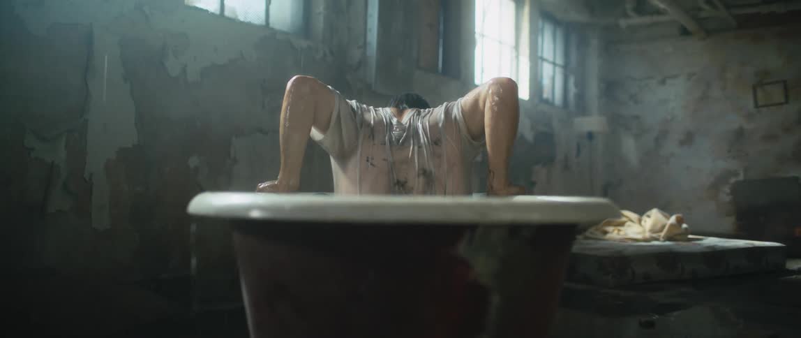 A man climbing out of a bath tub