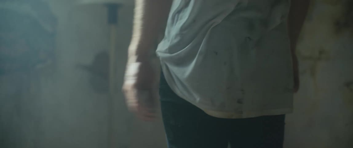 A person moves around in the dark room