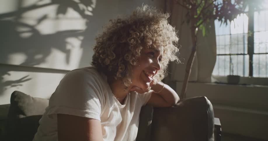 A woman sitting in a room smiling