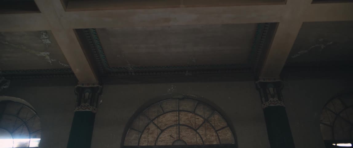 Floor to ceiling stained glass windows line the walls of a church