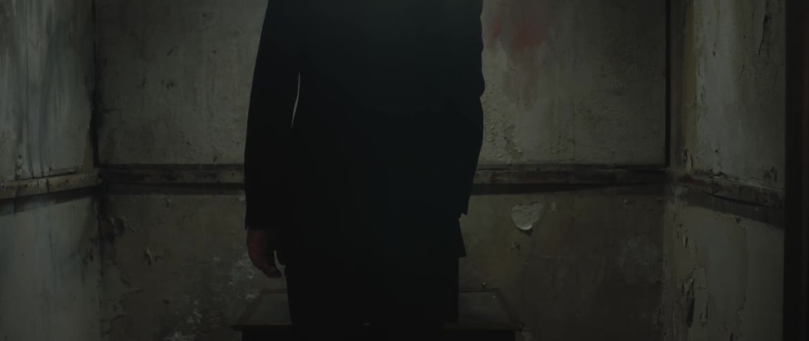 A man walks into a dungeon and turns on a record player