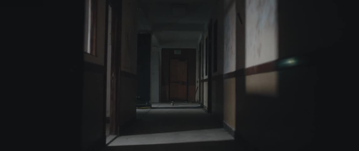 A dimly lit corridor in a building during the day
