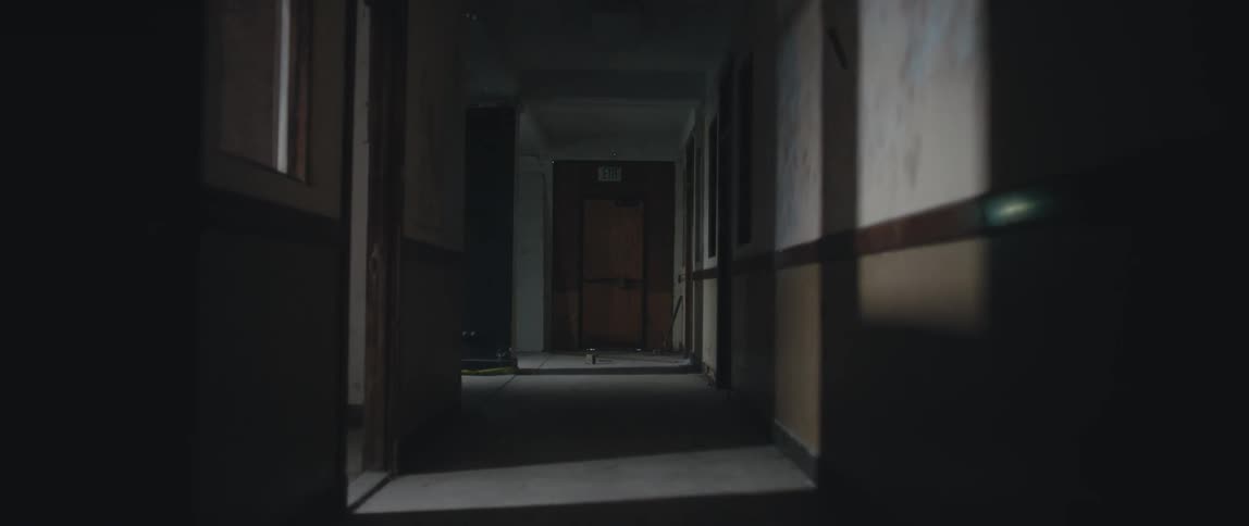 A dimly lit corridor in a building during the day