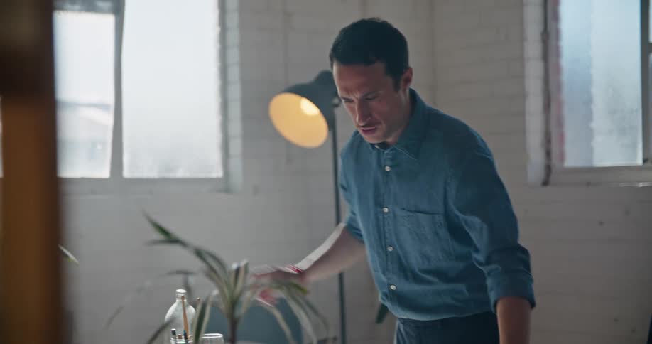 A man rolling up a piece of paper in an office