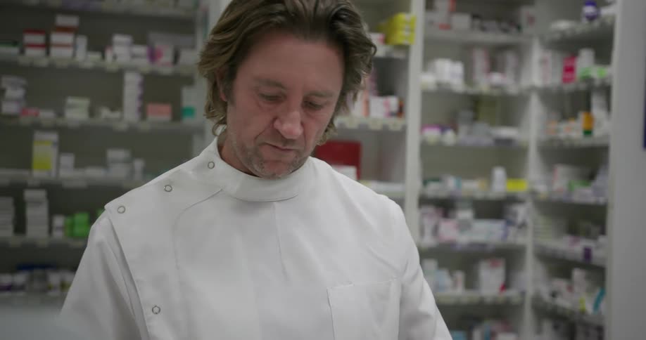 A pharmacist examines a bottle
