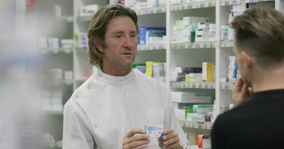 A pharmacists is talking to a customer