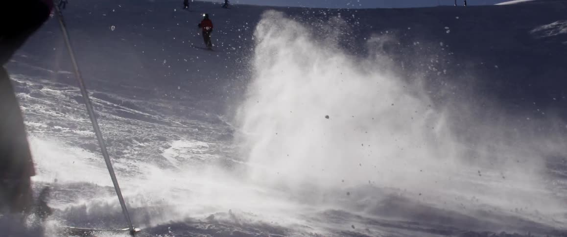A person skis on a sunny day