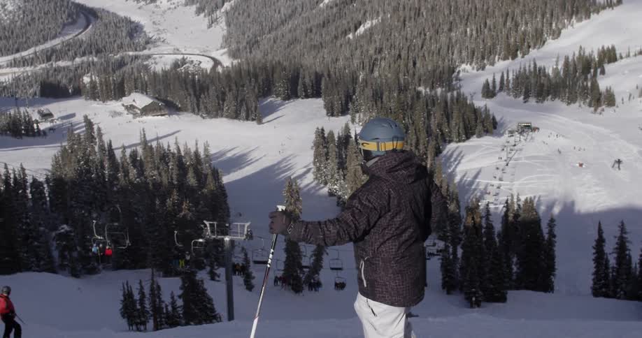 A person is on the top of a slope ready to ski down