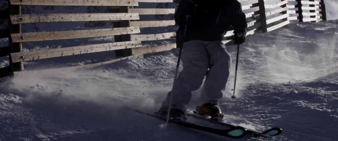 Slo mo of person downhill skiing