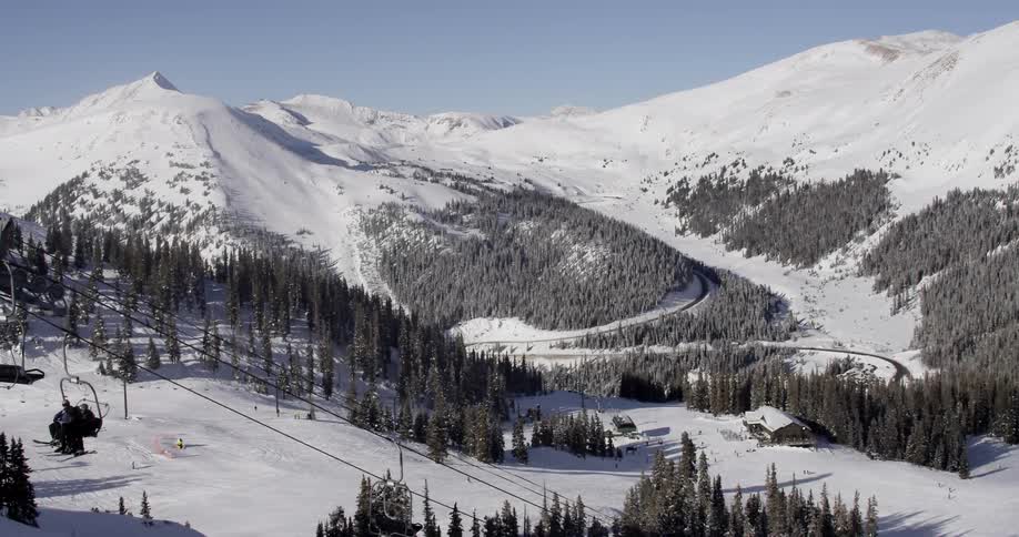 A ski lift in front of a mountain