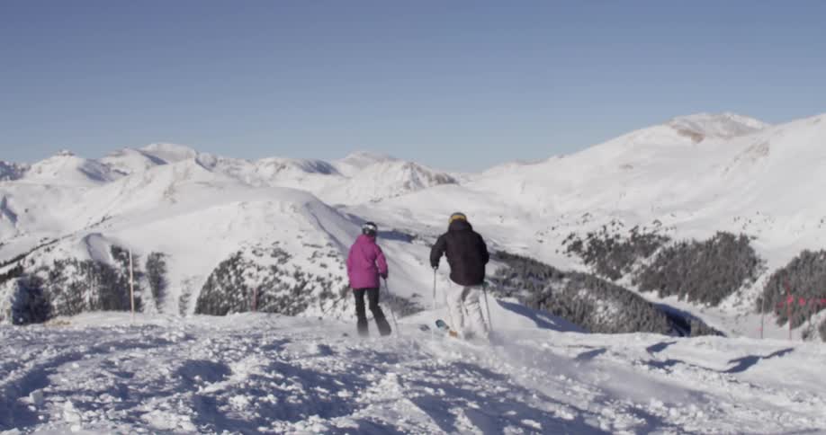 People skiing down a snowy mountain