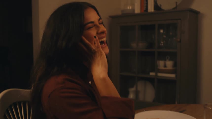 Women laugh at the table together