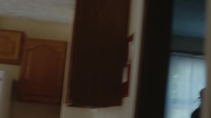 A teenagers grabs food food from the fridge
