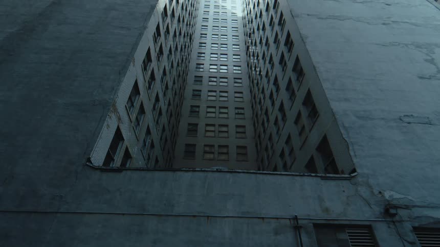 The tall apartment building reaches into the sky
