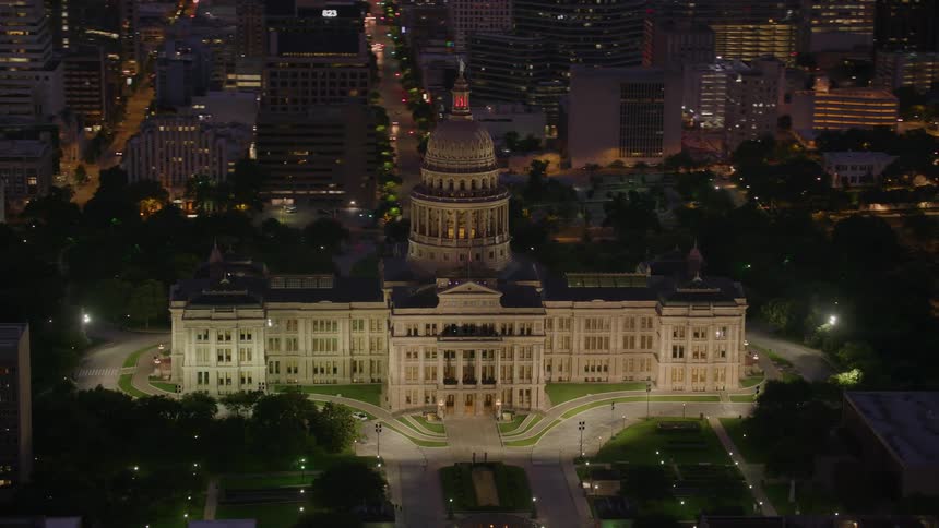 Traffic moves along city streets near the capitol building