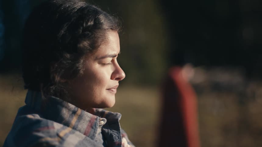 A woman watches the sunrise