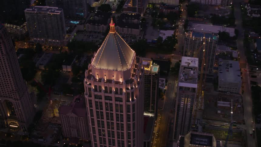 Lights glowing highlighting the one atlantic center building in atlanta at night