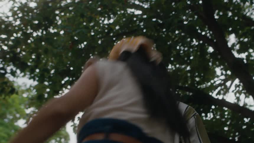 A man helps a girl up to his level before they walk away together