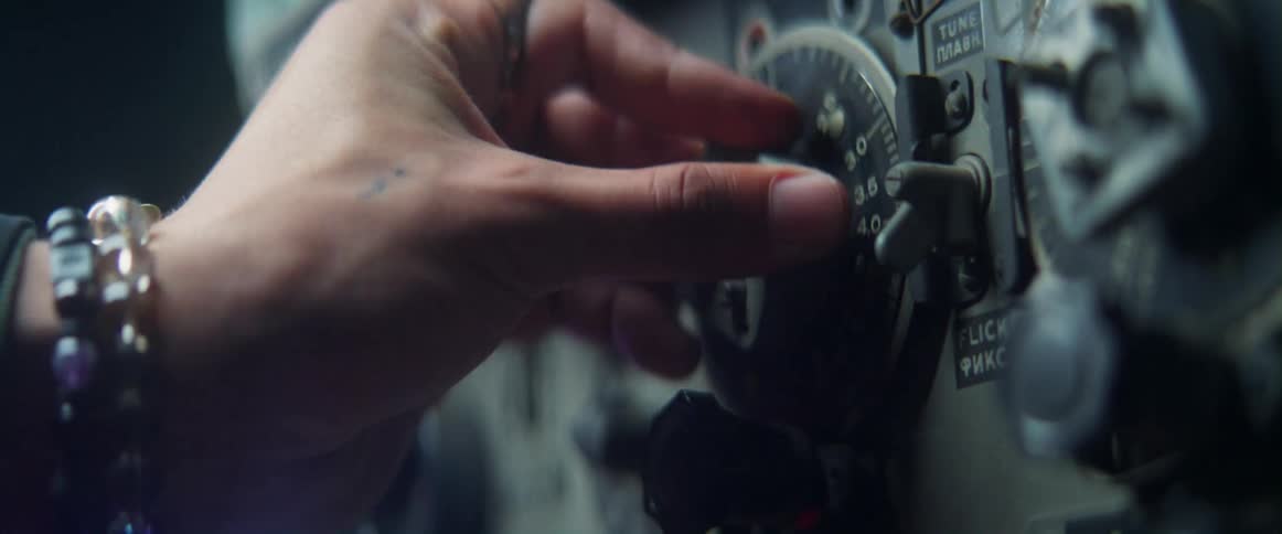 Person wearing bracelets turns dial to change setting