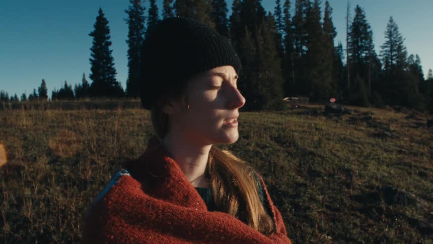 A woman watches the sunrise