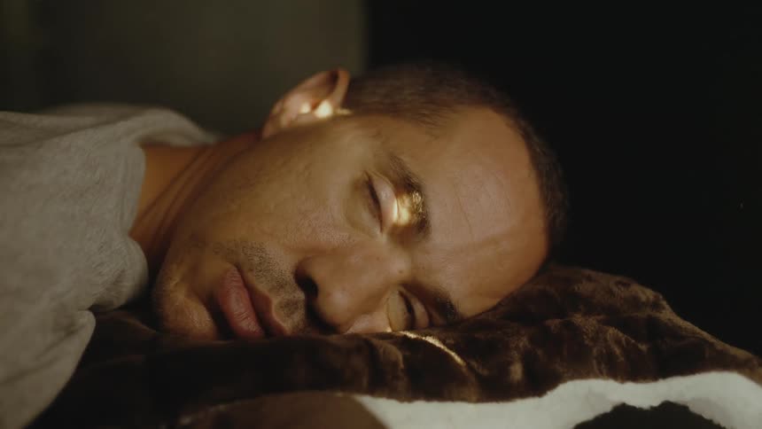 Dozing man wakes as sunlight shines onto his face