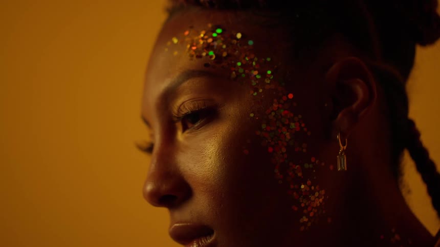 A woman turns her head as she poses