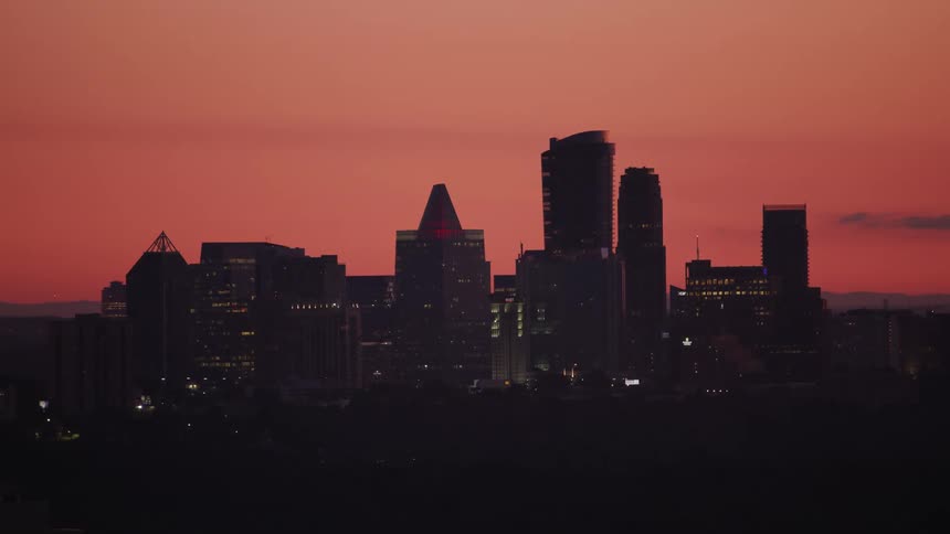 Aerial view of a downtown city at dusk is displayed