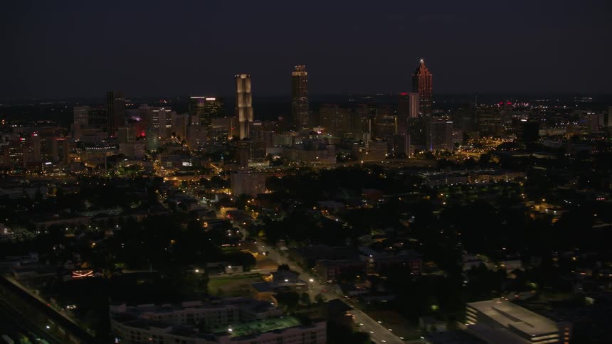 Aerial view of a downtown city at night is displayed