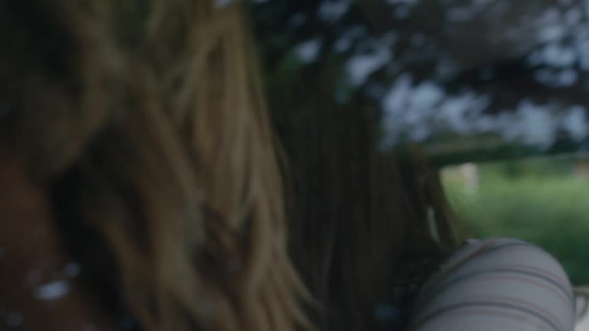 Two women greeting each other in a car