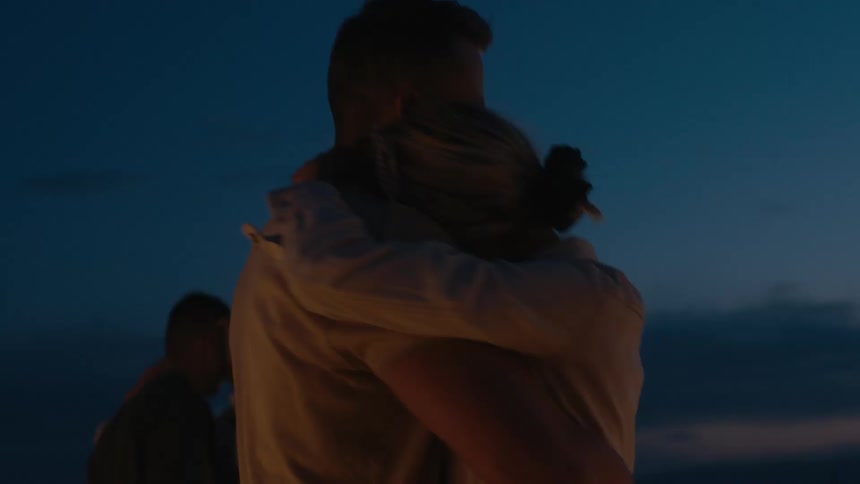 Happy couple dancing outdoors at night