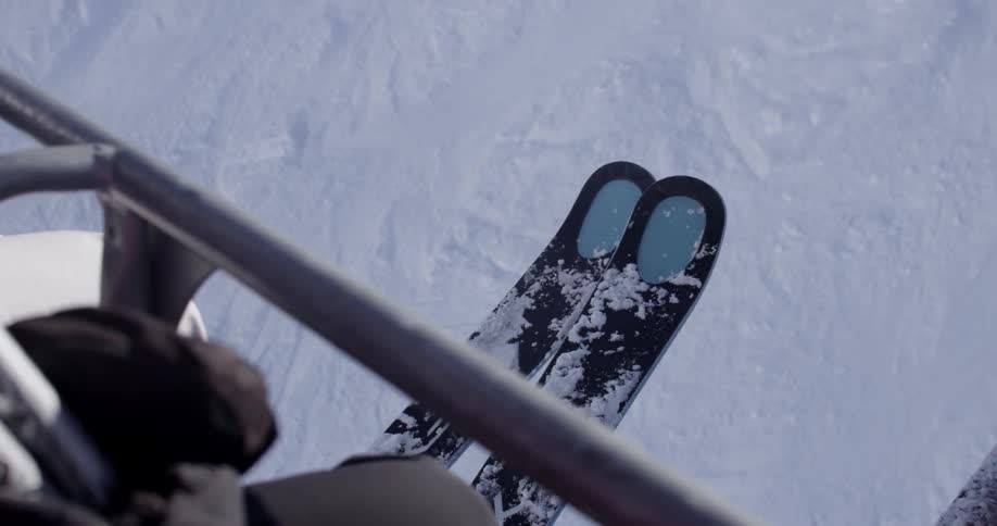 A ski lift with people traveling on it