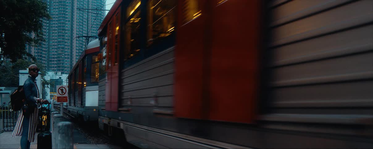 A person is waiting downtown for a city bus