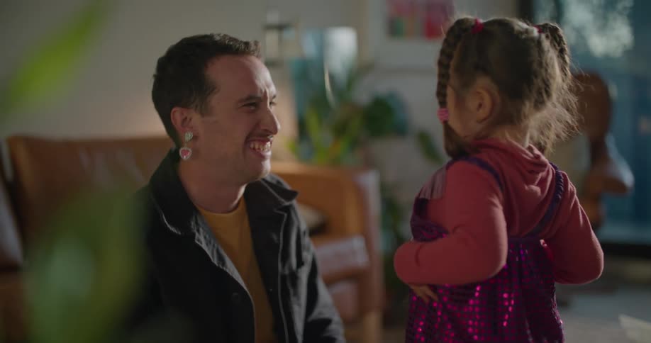 Father and toddler daughter wearing costumes playing on the living room at morning