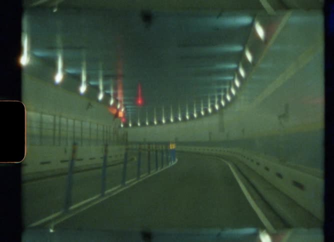 Footage of a tunnel where cars drive through is displayed