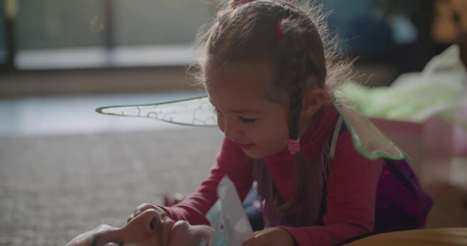 A father and daughter playing indoors