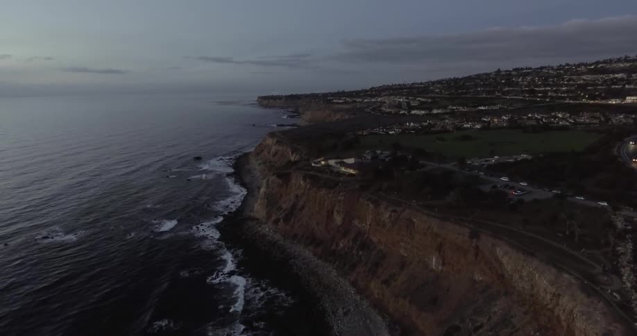 View of a cliff with water crashing against it