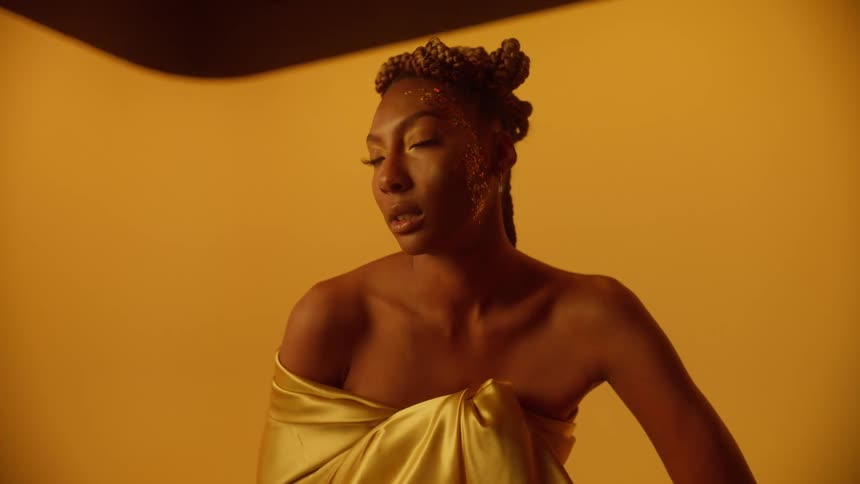 A female model is posing for the camera and wearing a robe