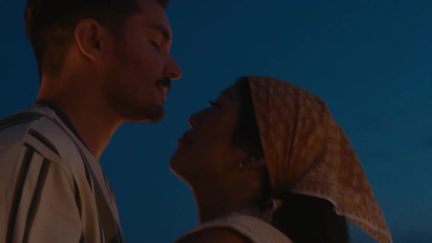 Couple dances and kisses outdoors at night