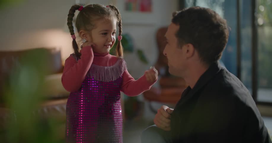 Father and toddler daughter wearing costumes playing on the living room at morning