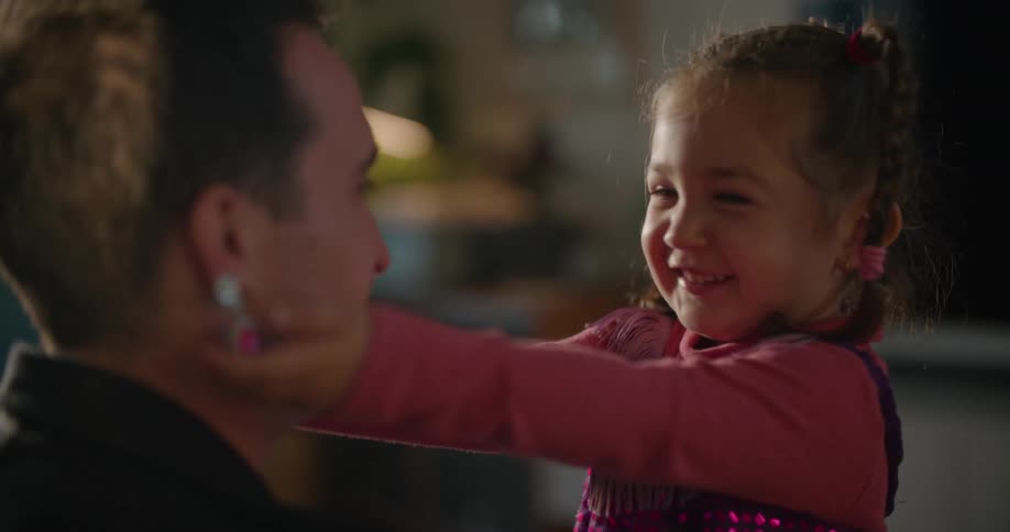 Father and toddler daughter wearing costumes playing on the living room at morning
