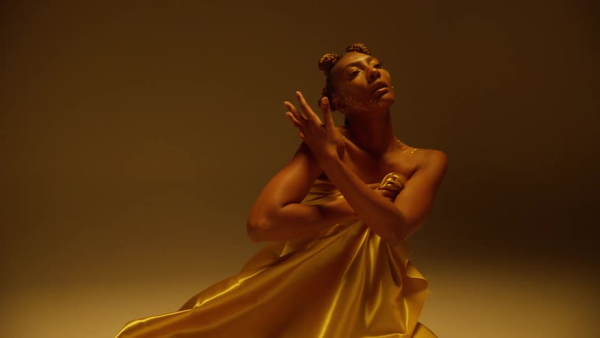 A woman is posing for the camera and wearing jewelry