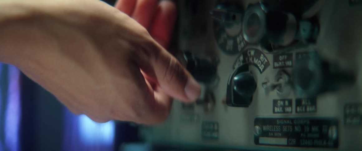 A person turns a knob of a console back and forth