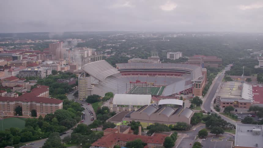 Aerial view of a stadium in a downtown city is displayed
