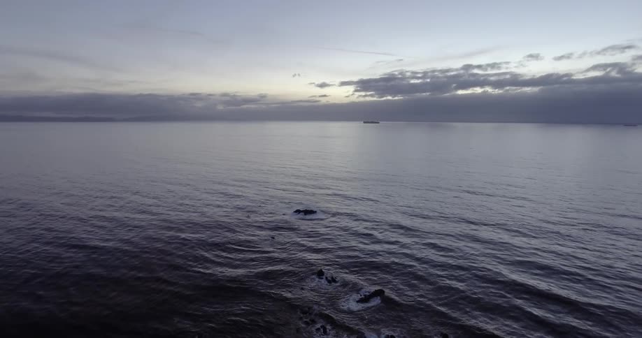 Aerial view of an ocean at sunset