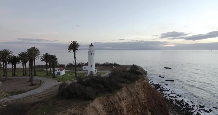 Moving towards a lighthouse near the edge of a cliff