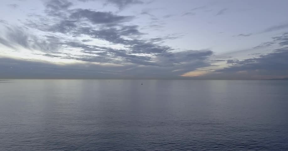 The ocean gently rippling under a cloudy sky