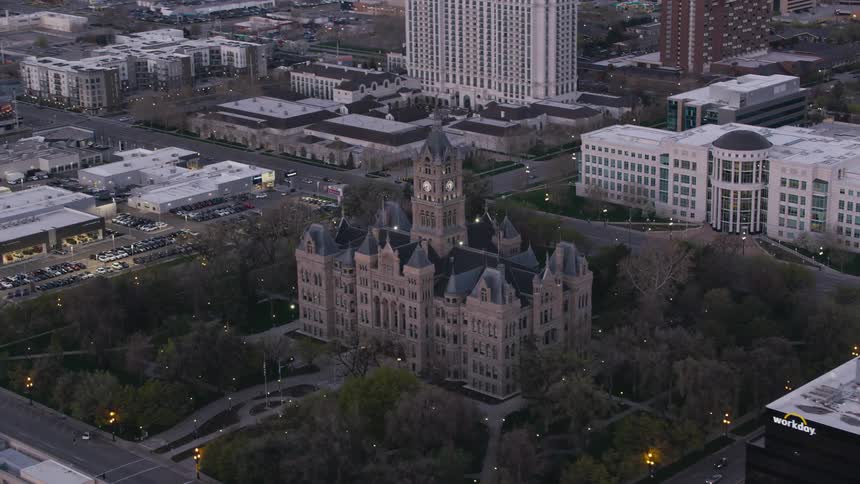 Lights twinkle in bushes surround a downtown cathedral