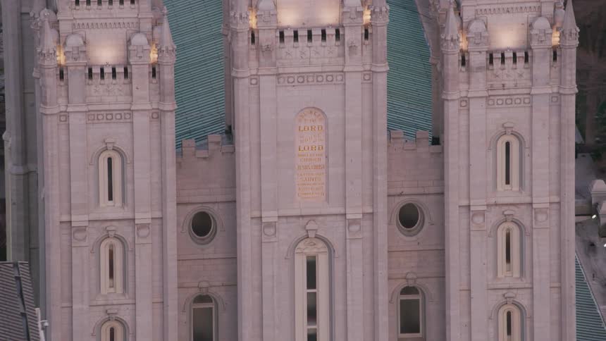 An american flag flies on a dome near a building with beautiful architecture